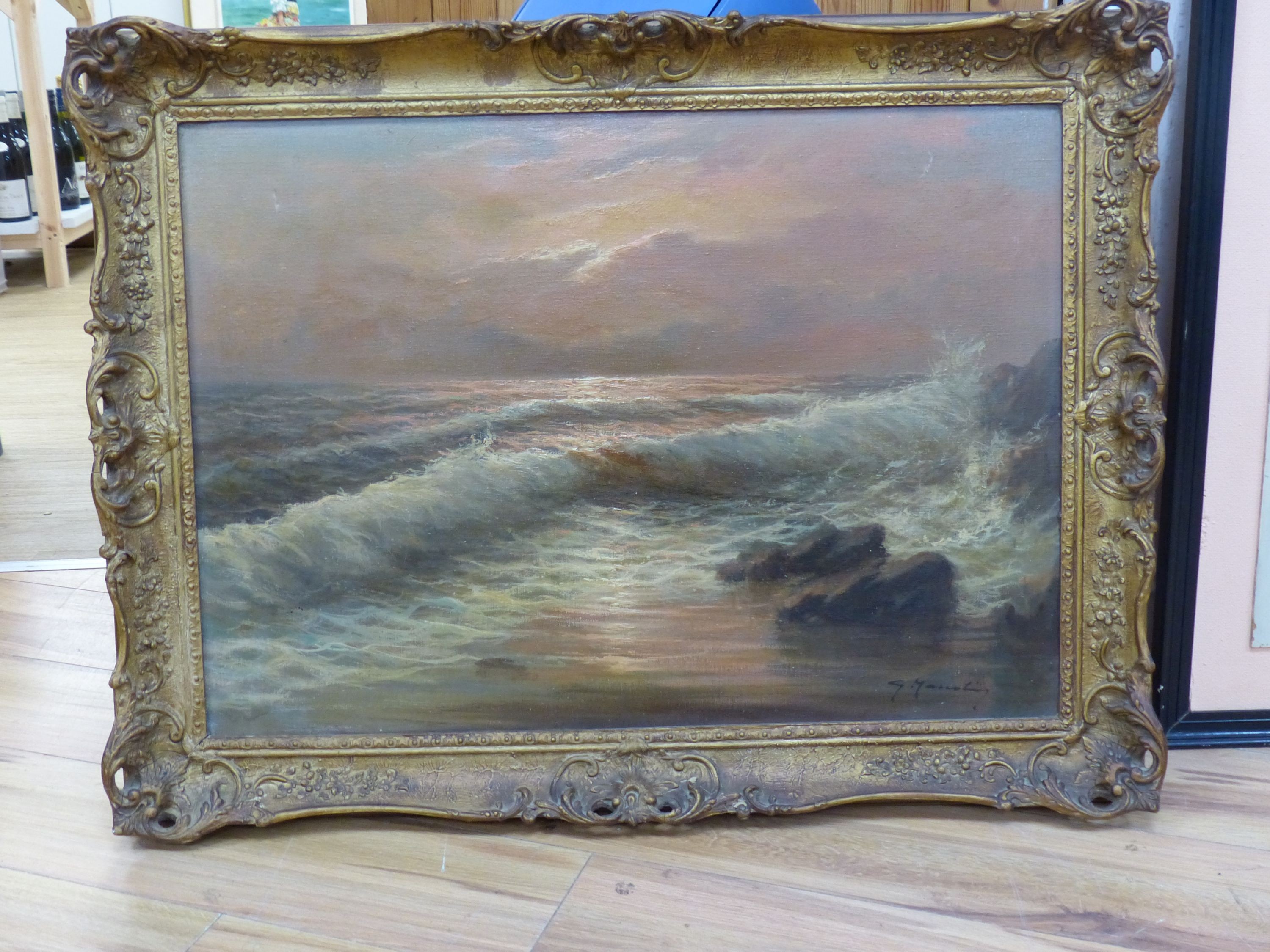 English School, oil on canvas, Waves breaking against the shore at sunset, indistinctly signed, 50 x 70cm